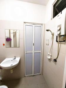 a bathroom with a sink and a shower at TuR15 PisaStadium 4rooms PrivateHouse in Bayan Lepas