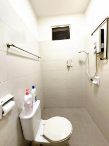 a white bathroom with a toilet and a shower at TuR15 PisaStadium 4rooms PrivateHouse in Bayan Lepas