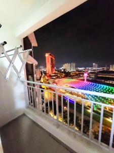 a balcony with a view of a city at night at TuR15 PisaStadium 4rooms PrivateHouse in Bayan Lepas