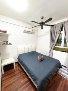 a bedroom with a bed and a ceiling fan at TuR15 PisaStadium 4rooms PrivateHouse in Bayan Lepas