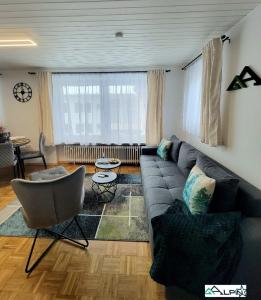 a living room with a couch and a chair at Ferienwohnung Alpinstar - inklusive Oberstaufen Plus in Oberstaufen