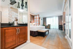 a hotel room with a bed and a bathroom at Signature Rental by Owner Direct in Las Vegas