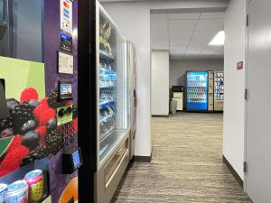 an empty aisle in a store with a refrigerator at Downtown 1br Gem Steps Away From Wells Fargo in Des Moines