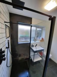 a bathroom with a sink and a window at 5-Bedroom home - Ideal for groups working away from home in Swansea