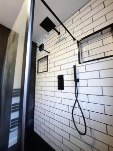 a hose hooked up to a white brick wall at 5-Bedroom home - Ideal for groups working away from home in Swansea