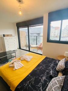 Lovely flat in Tel Aviv 32 في تل أبيب: غرفة نوم بسرير كبير مع شراشف صفراء