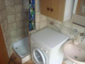 a bathroom with a washing machine and a sink at Guntern in Lauerz - b48507 in Lauerz