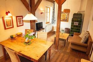 a living room with a wooden table and a dining room at Wohnung in Haselberg mit Großem Garten - b48515 in Wriezen