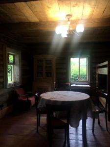 a room with a table and chairs and a ceiling at Historische Haus unter der Linde - b48528 in Krzyszkowice