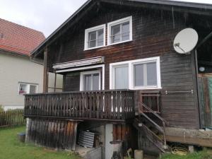 a house with a balcony and a satellite at Ferienhaus Rheintalblick - b48550 in Oberegg