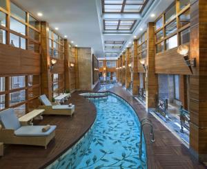 a hotel lobby with a large swimming pool at Hilton Dalaman Sarigerme Resort & Golf in Dalaman