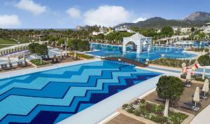 an overhead view of a pool at a resort at Hilton Dalaman Sarigerme Resort & Golf in Dalaman +146 photos