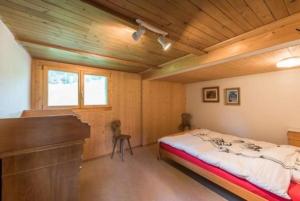 a bedroom with a bed and a piano at Haus Eberli-Bussmann - b48553 in Giswil