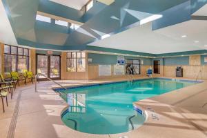 a large swimming pool with blue water in a building at Best Western Plus Fairburn Atlanta Southwest in Fairburn