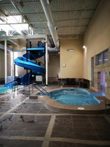 a large indoor pool with a slide in a building at Sweet Condo Canmore GR：） in Canmore