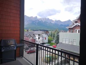 a balcony with a view of the mountains at Sweet Condo Canmore GR：） in Canmore