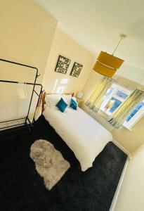 a bedroom with a white bed and a window at Your Staycation in Bristol