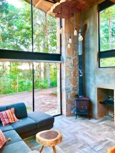 a living room with a couch and a fireplace at Bolonchon cabin. Comfortable, modern and cozy in San Cristóbal de Las Casas