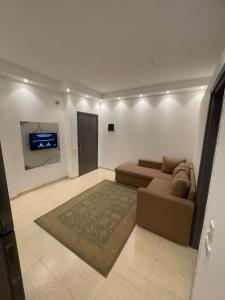 a living room with a couch and a tv at Apartments in Florenza Khamsin in Hurghada