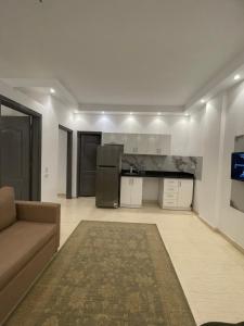 a living room with a couch and a kitchen at Apartments in Florenza Khamsin in Hurghada