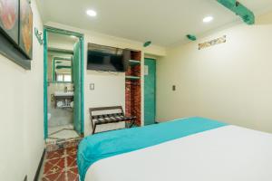 Postel nebo postele na pokoji v ubytování Hotel Casa Antigua