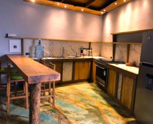 a kitchen with a wooden table and a stove at Frondavista San Pancho in San Francisco