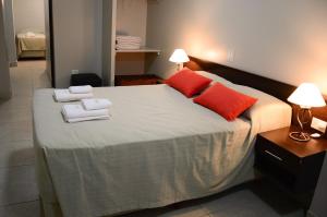 a bedroom with a large bed with towels on it at Munay Ledesma in Libertador General San Martín