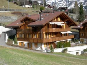 a large wooden house with a roof at Chamonix 2-Bettwohnung - b48634 in Grindelwald