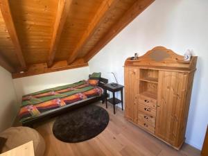 a bedroom with a bed and a wooden ceiling at Casa Marianne - b48614 in Flims