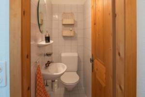 a small bathroom with a toilet and a sink at Casa Marianne - b48614 in Flims