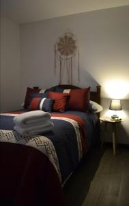 a bedroom with a bed with a fan on the wall at Suite Zen in Guatemala