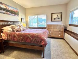 a bedroom with a bed and a dresser and a window at The Stone Hill House, Grand Lake, Colorado IN TOWN with Lake View in Grand Lake