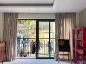 a room with a sliding glass door to a balcony at Dahlia Homestay Tay Ho in Hanoi