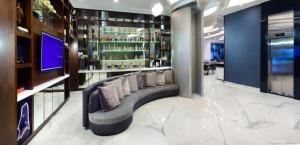 a lobby with a couch and a bar at Hotel Guadalajara Country Club by HNF in Guadalajara