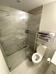 a bathroom with a toilet and a glass shower at Luxury unit in the heart of Canmore in Canmore