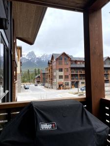 a window with a view of a street and mountains at Luxury unit in the heart of Canmore in Canmore