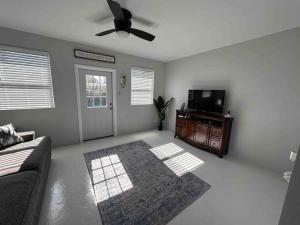 a living room with a couch and a flat screen tv at Sea Turtle Cove in Clearwater