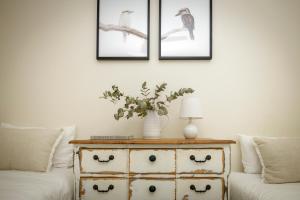 a living room with a couch and a table with a vase at The Cottages On Mount Tamborine in Mount Tamborine