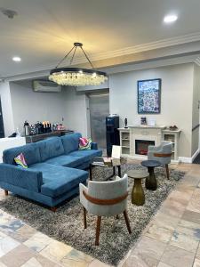 a living room with a blue couch and a fireplace at Bel Abri Napa Valley Inn in Napa