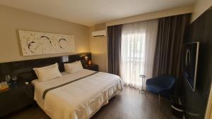 En eller flere senge i et værelse på Hotel Boutique Itaim + 26 billeder