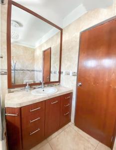 a bathroom with a sink and a mirror at D'eluxe Hotel Talara ubicado a 5 minutos del aeropuerto y a 8 minutos del Centro Civico in Talara