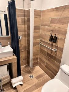 a bathroom with a shower with a sink and a toilet at Centrico House in Taxco de Alarcón