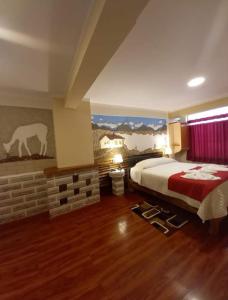 a bedroom with a bed and a painting on the wall at Hotel REY DAVID in Uyuni