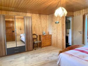 a bedroom with a bed and a dresser and a mirror at La Ferme - b48766 
