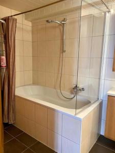 a bathroom with a bath tub with a shower at La Ferme - b48766 