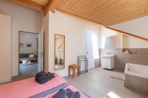 a bedroom with a large bed and a bathroom at Bergliebe - b48774 in Melchtal