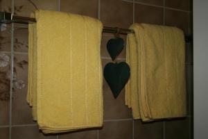 a bathroom with yellow towels with a heart on them at Ferienwohnung mit Herz - b48778 in Horboden
