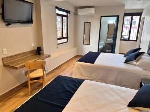 A bed or beds in a room at Centrico House