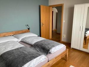 a bed in a room with a wooden headboard at Ferienwohnung Seehof - b48779 in Rorschacherberg