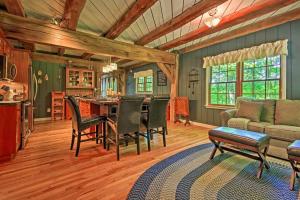 a kitchen and living room with a table and chairs at Bear's Eye View - Mountain Retreat w/ Hot Tub! in Acme